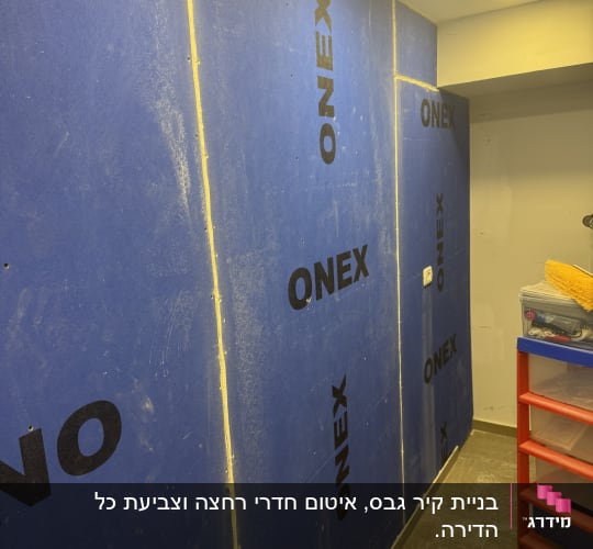 קירות גבס כחולים עם לוגו ONEX בתהליך שיפוץ